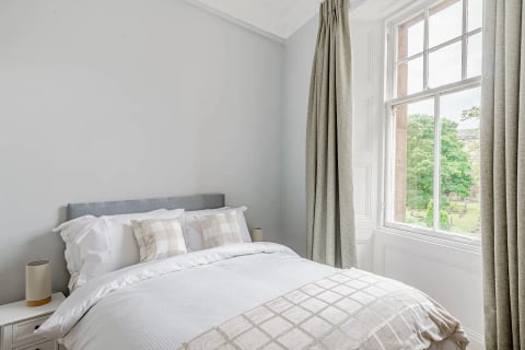King bed with check cushions and ladder shelf