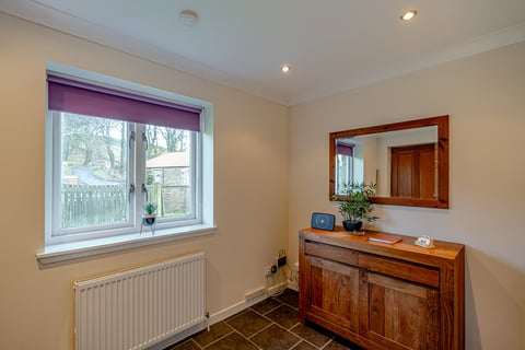 Hall dresser beneath the mirror with radiator