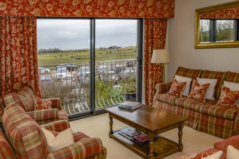 Sitting room with balcony doors onto the course