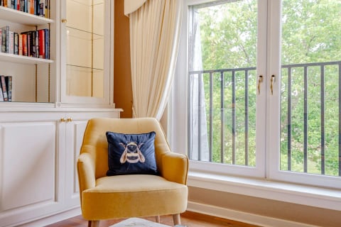 Armchair by the Juliet balcony overlooking the trees